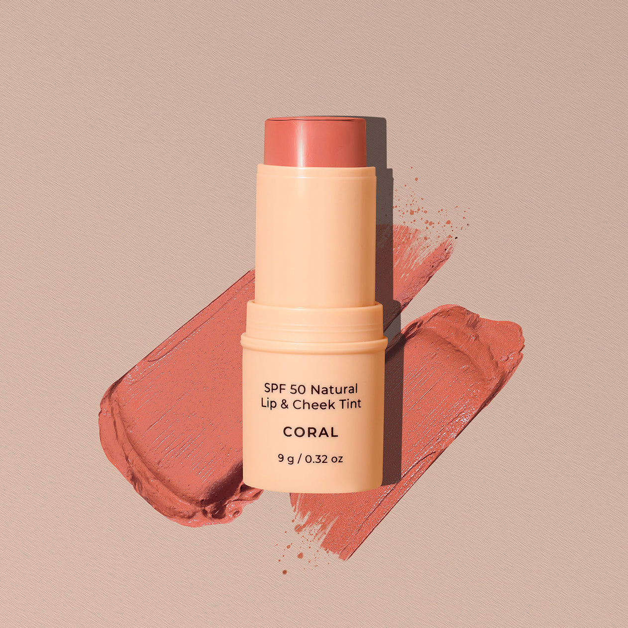 SPF 50 Natural Lip & Cheek Tint stick in Coral on a beige background avocado zinc